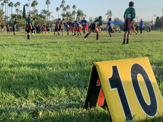field with middle schoolers playing flag football