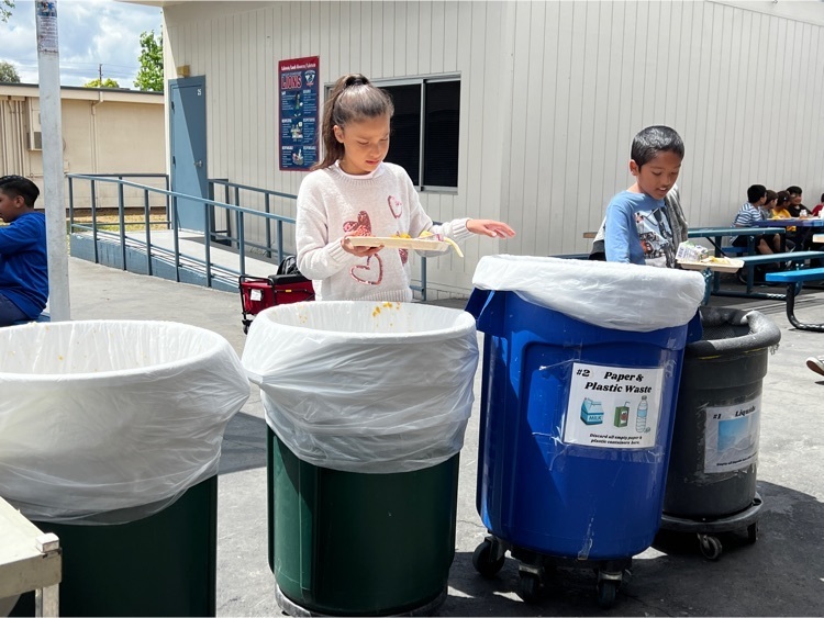 girl and boy at lunch recycling binS
