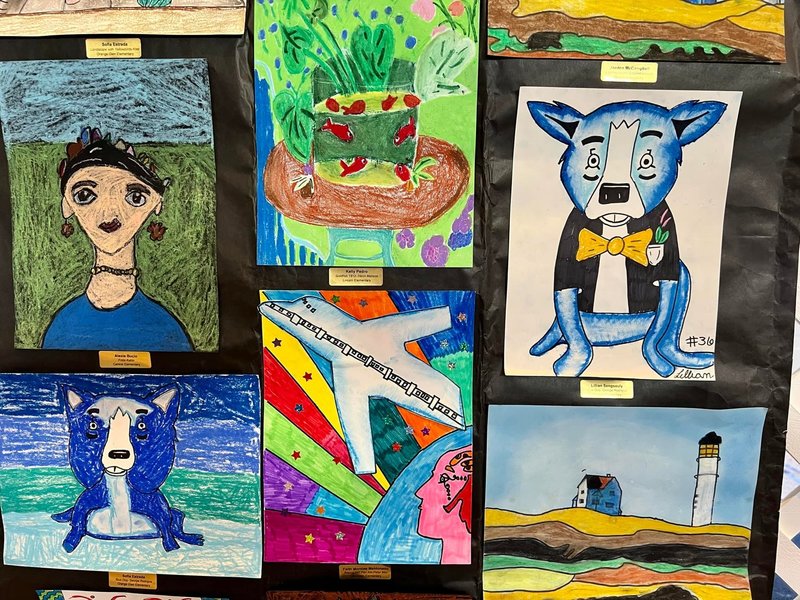 student art work at art show. drawings of people, landscapes, and animals