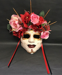 red and pink flowers on Dia de los Muertos mask