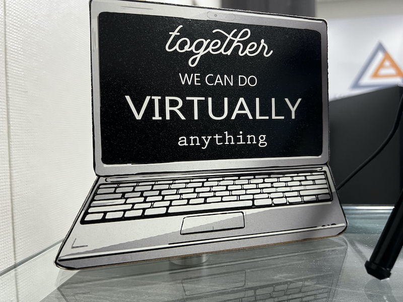 sign of laptop computer saying "together we can do virtually anything"