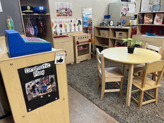 play area of TK classroom with small table and play kitchen