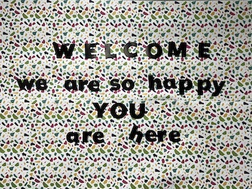 bulletin board with cutout letters saying WELCOME we are so happy YOU are here