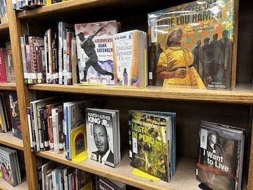 close up photo of nonfiction library books on display on two shelves